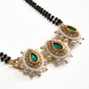 Long mangalsutra with green stone pendant, black beads chain, and matching earrings