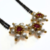 Moti Kudi short mangalsutra with white pearls and three-flower pendant, matching earrings included
