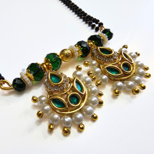 Long mangalsutra with green stone and green Kundan pendant, two-stranded black beads, and matching earrings